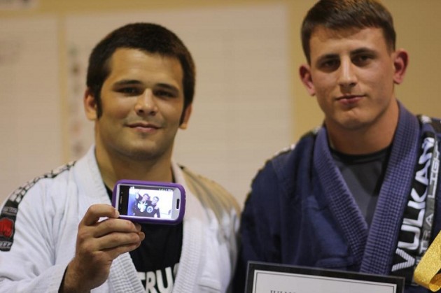 Master Roberto holding up a picture of Jullian getting Team Third Law's first medal.