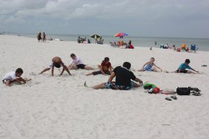 Stretching before a Muay Thai Kickboxing Class at the beach- Naples Best Summercamp