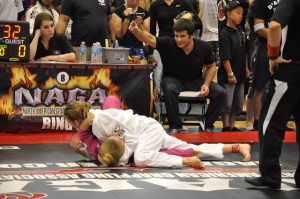 Rachel Ranschau, who trains in Naples in the Third Law BJJ Teens class, pins her opponent in side control after sweeping with an ommaplata sweep. She won this match for gold.